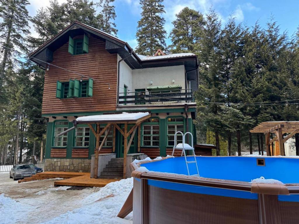 a house with a pool in front of it at Villa Rila Borovets Mountain & Luxury with Hot Jacuzzi & Sauna in Borovets