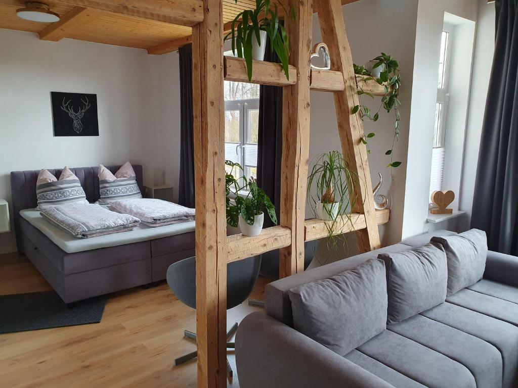 a living room with a couch and a loft bed at Haus Sonnenblick in Benneckenstein