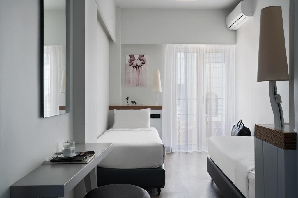 Postel nebo postele na pokoji v ubytování Lato Boutique Hotel