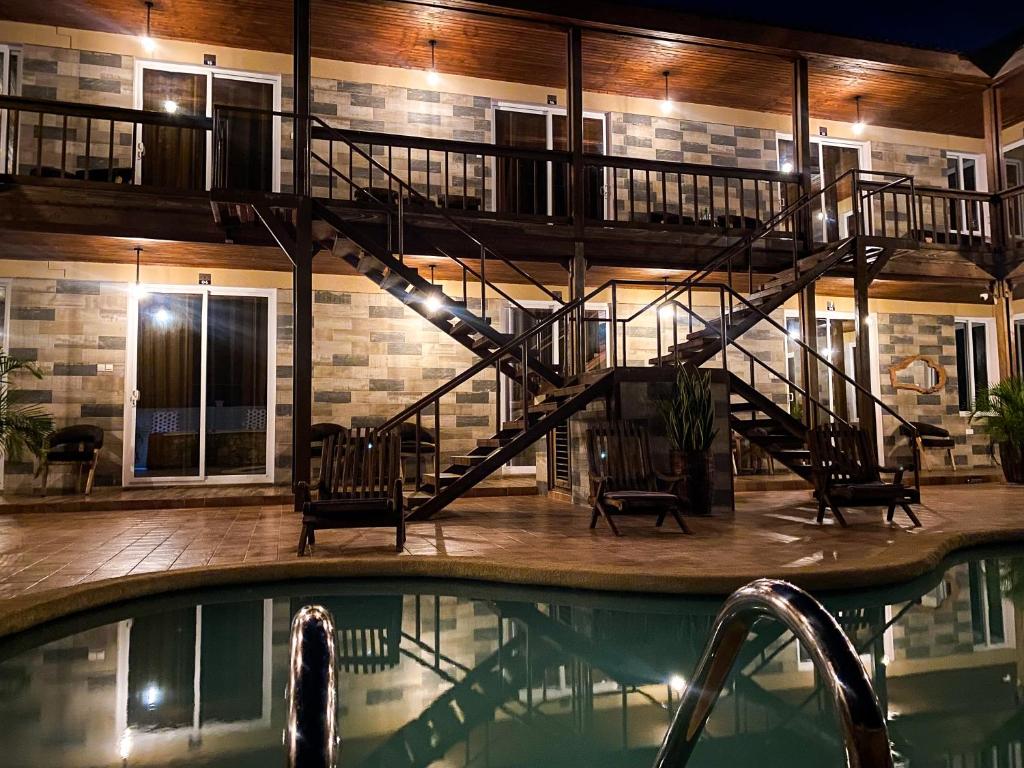 a swimming pool with a staircase in a building at Tajiri Studio Flats - Mbezi Beach - Comfort, Convenience, Privacy and Security Guaranteed in Dar es Salaam
