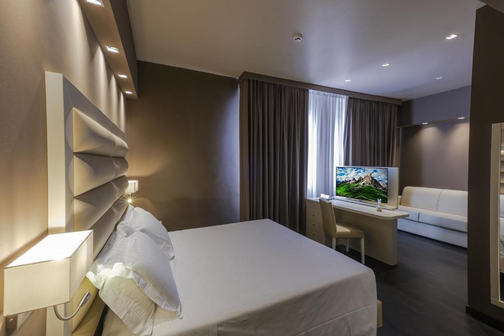 Postel nebo postele na pokoji v ubytování Hotel Touring