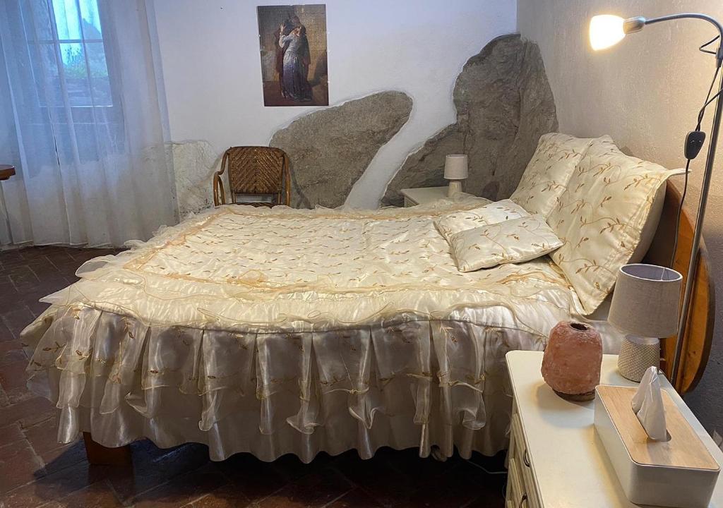 a bedroom with a bed with a table and a lamp at Casa Vacanze Paradise in Roccastrada