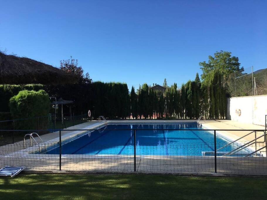 a swimming pool with a fence around it at Apartamento Espert Biescas in Biescas