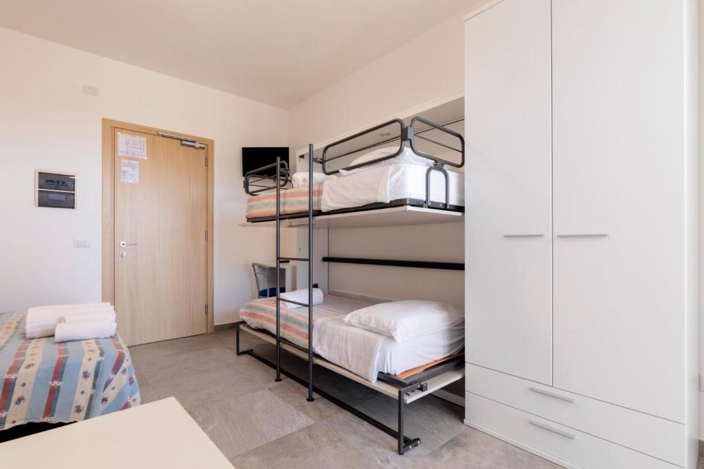a bedroom with bunk beds and a closet at Camping Villaggio Il Frutteto in Cupra Marittima