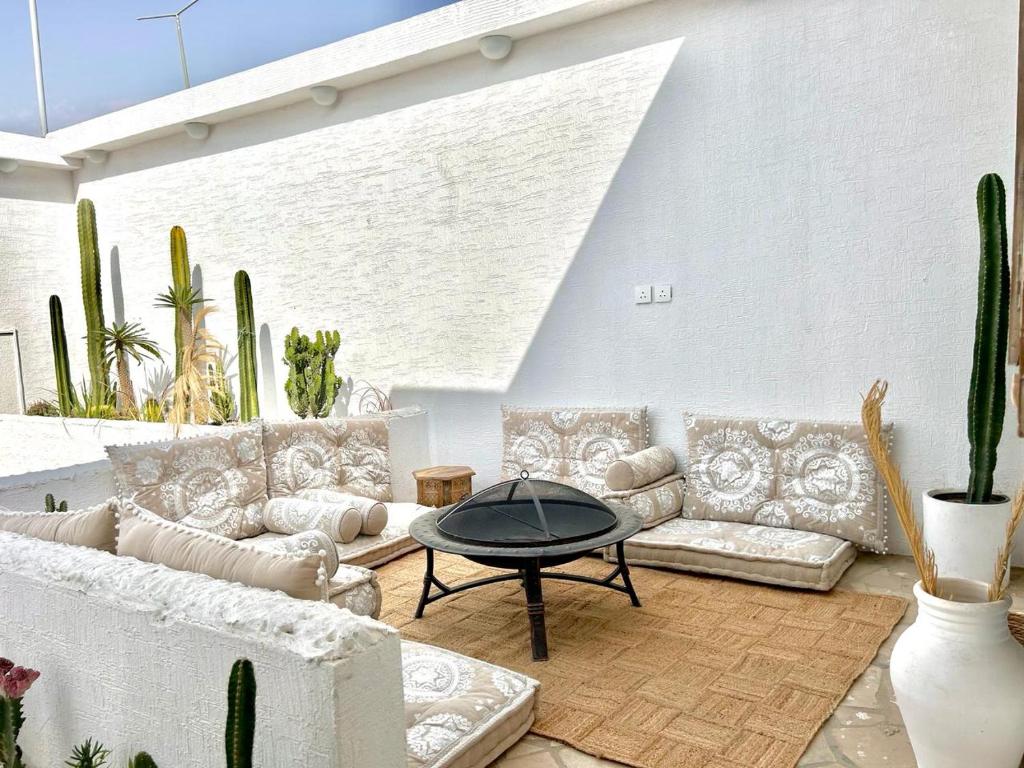 a living room with couches and a table and cactus at شاليه مثوى الصباريات in Riyadh