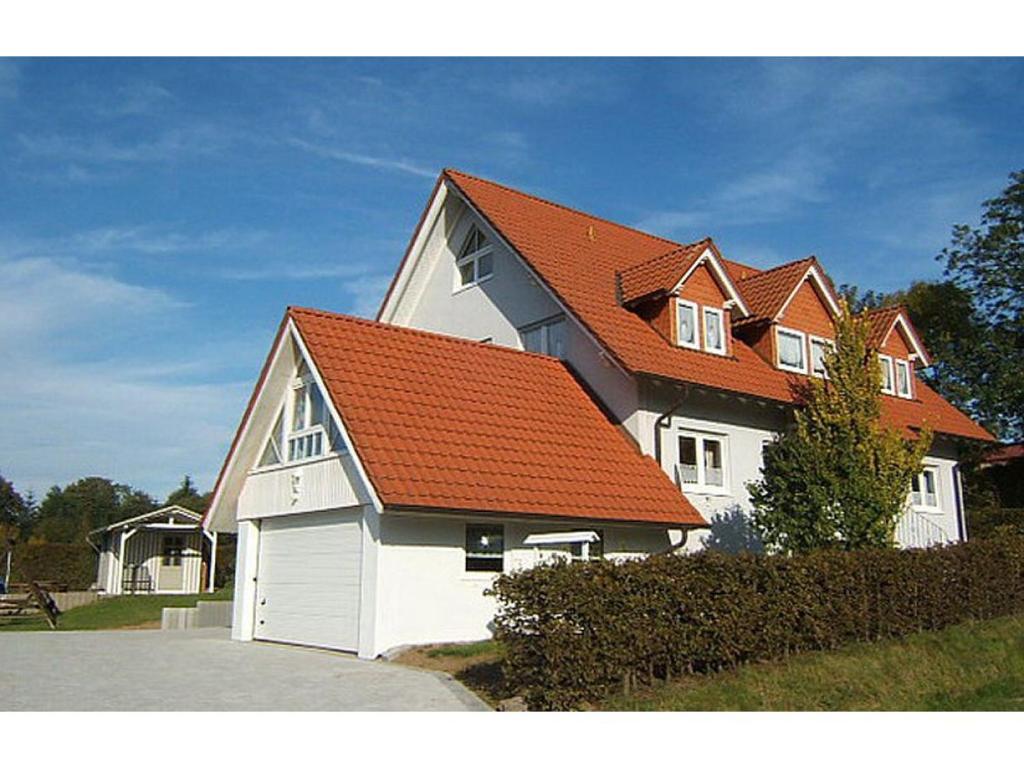 a large white house with an orange roof at Ferienzimmer Schneider in Herbstein