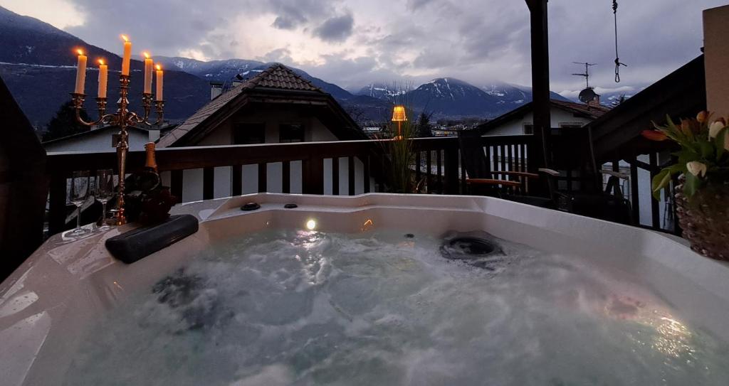 a jacuzzi tub on the balcony of a house at Penthouse&Wellness L'Abete in Gargazzone