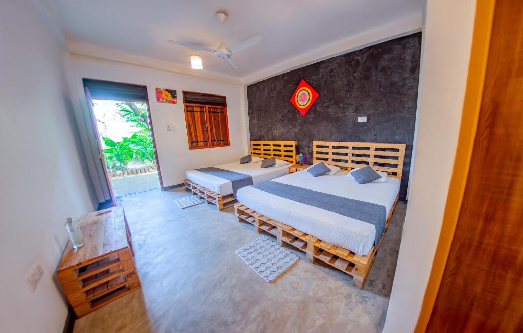 a bedroom with two beds and a window at Inside Out Nature Villa in Kandy