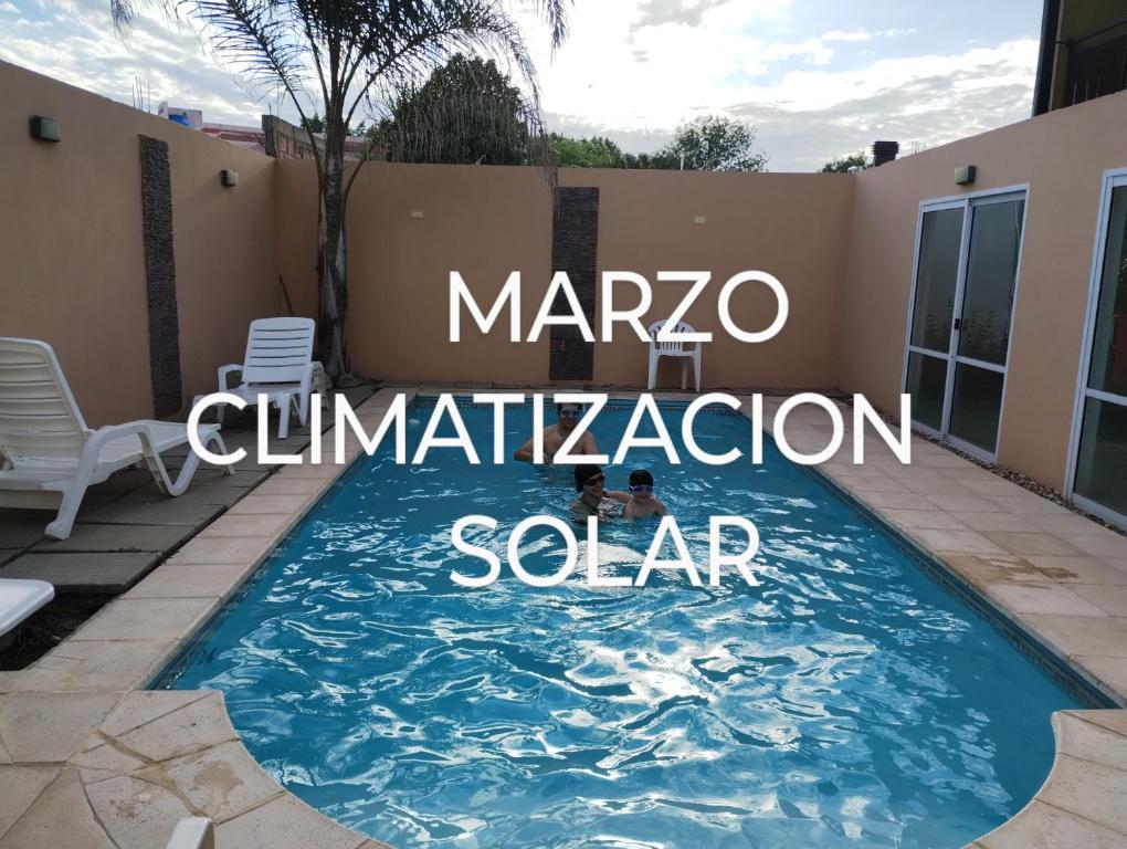 a swimming pool in the backyard of a house at Sol de Belen in San José