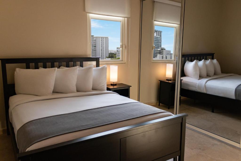 Postel nebo postele na pokoji v ubytování Ciqala Suites Hotel - San Juan
