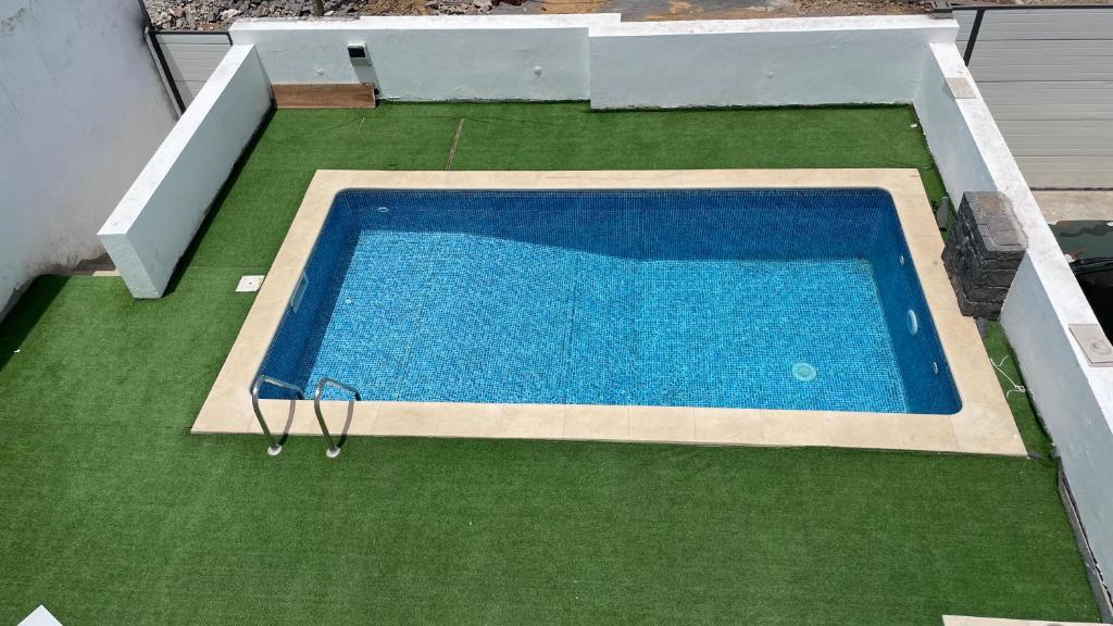 an overhead view of a swimming pool on grass at Palmira House in Cidade Velha
