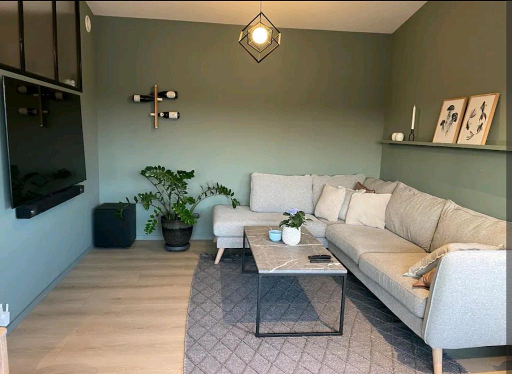 a living room with a couch and a coffee table at Modern house near the ocean in Sandefjord