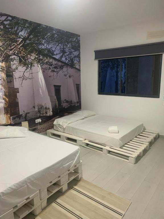Postel nebo postele na pokoji v ubytování Palmira House