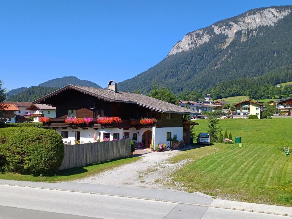 a house on the side of a road with a mountain at Haus Barbara in Söll