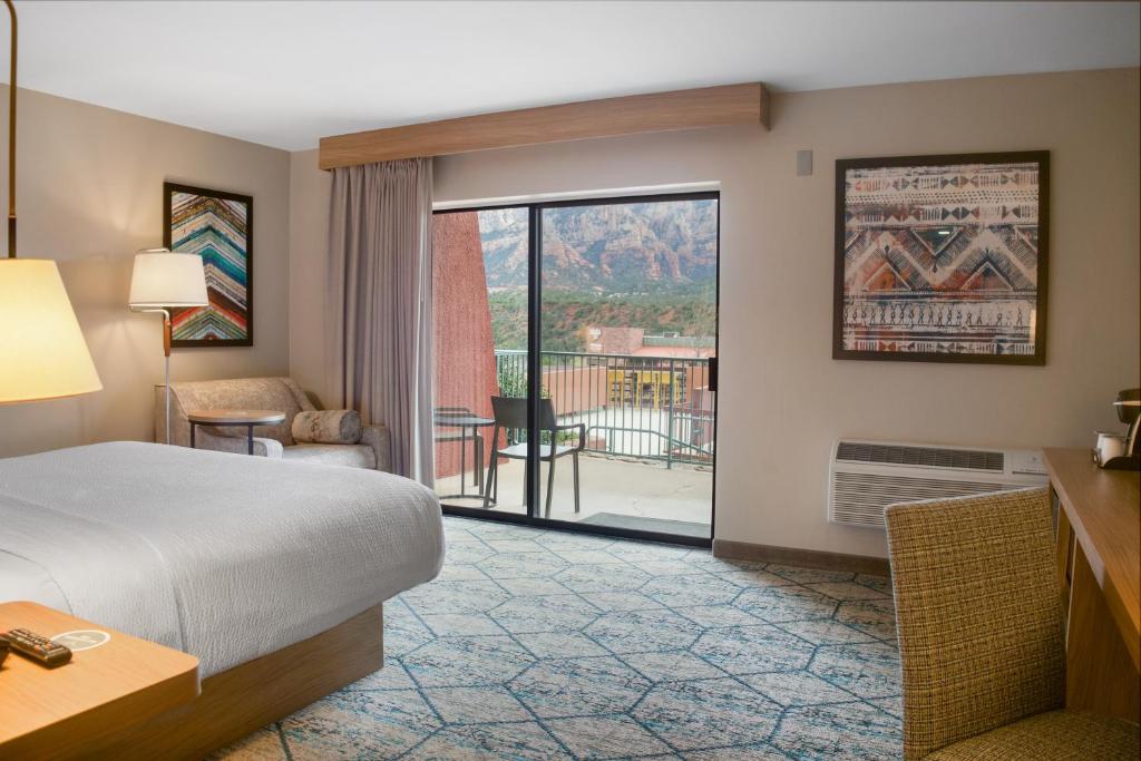 a hotel room with a bed and a balcony at Matterhorn Inn in Sedona