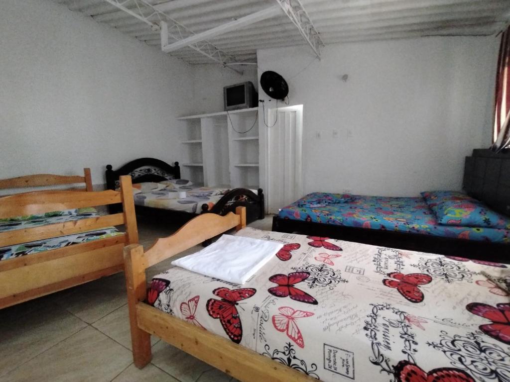 a room with two beds and two beds sidx sidx sidx sidx at Hotel santa marta Melgar in Melgar