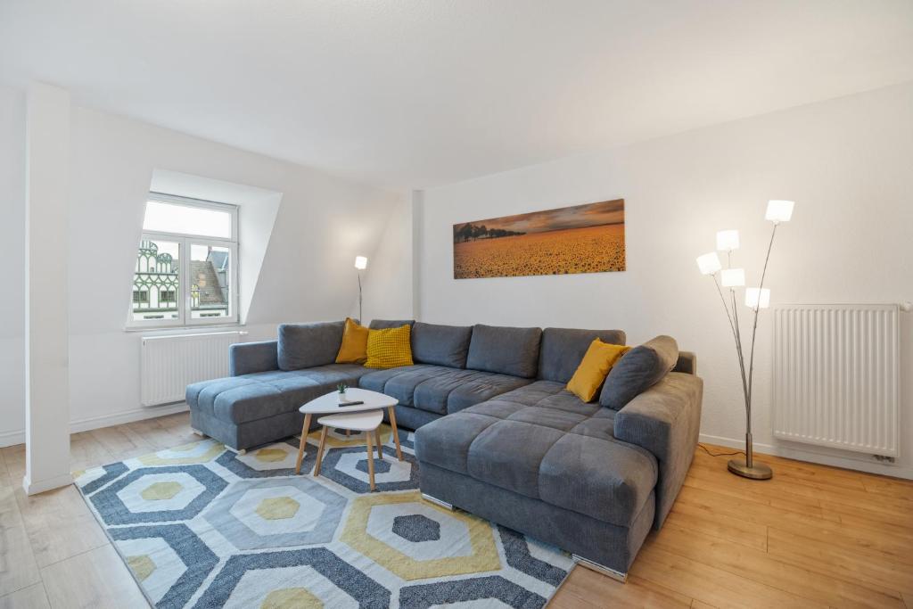 a living room with a couch and a table at City Center Maisonette Apartment für 8 Personen in Weimar