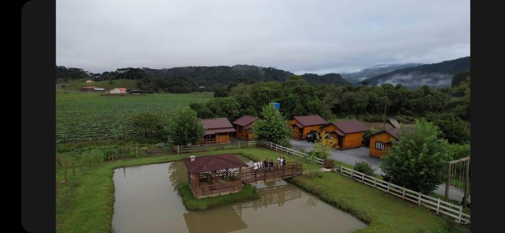 an aerial view of a house and a river at Pousada rio canoas in Urubici