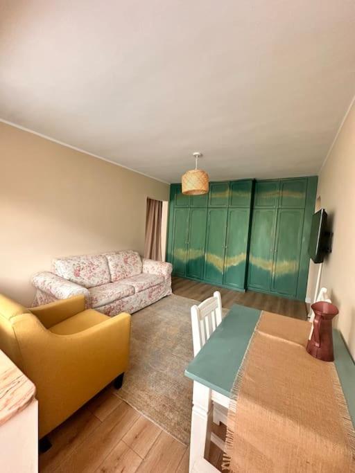 a living room with a couch and a table at Cozy apartment in Galati in Galaţi