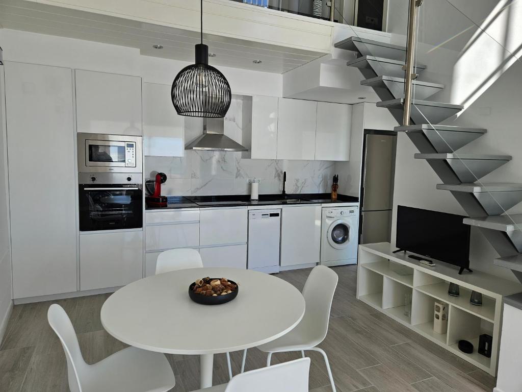 A kitchen or kitchenette at FANTÁSTICO DÚPLEX CON VISTAS IMPRESIONANTES AL MAR