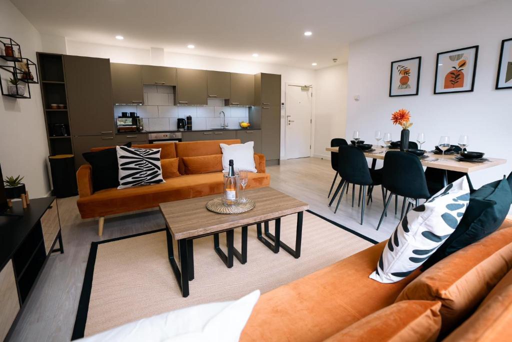 a living room with a couch and a table at Modern City Centre Apartment in Exeter