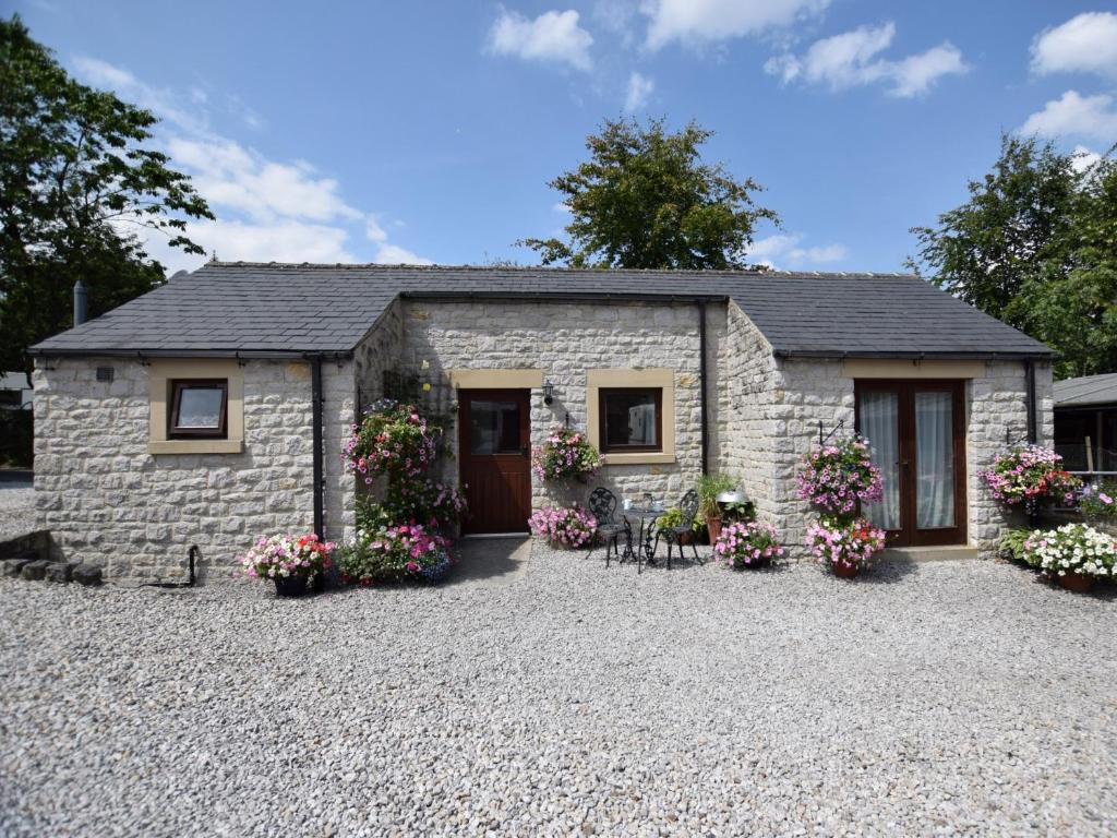 a stone house with flowers in front of it at 1 Bed in Bradwell PK849 in Bradwell