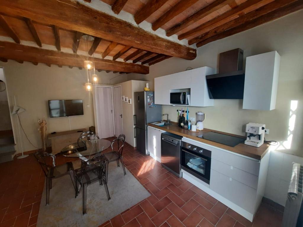 a kitchen and dining room with a table and a dining room at Golden House in Capannori