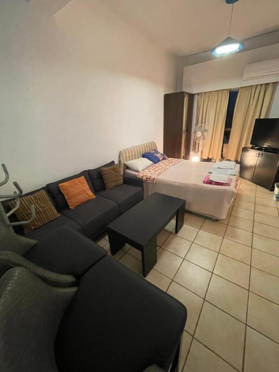 a living room with a couch and a table at Studio apartment in Larnaca