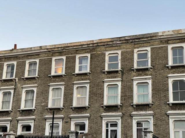 a large brick building with white windows on it at RSB Inn London in London