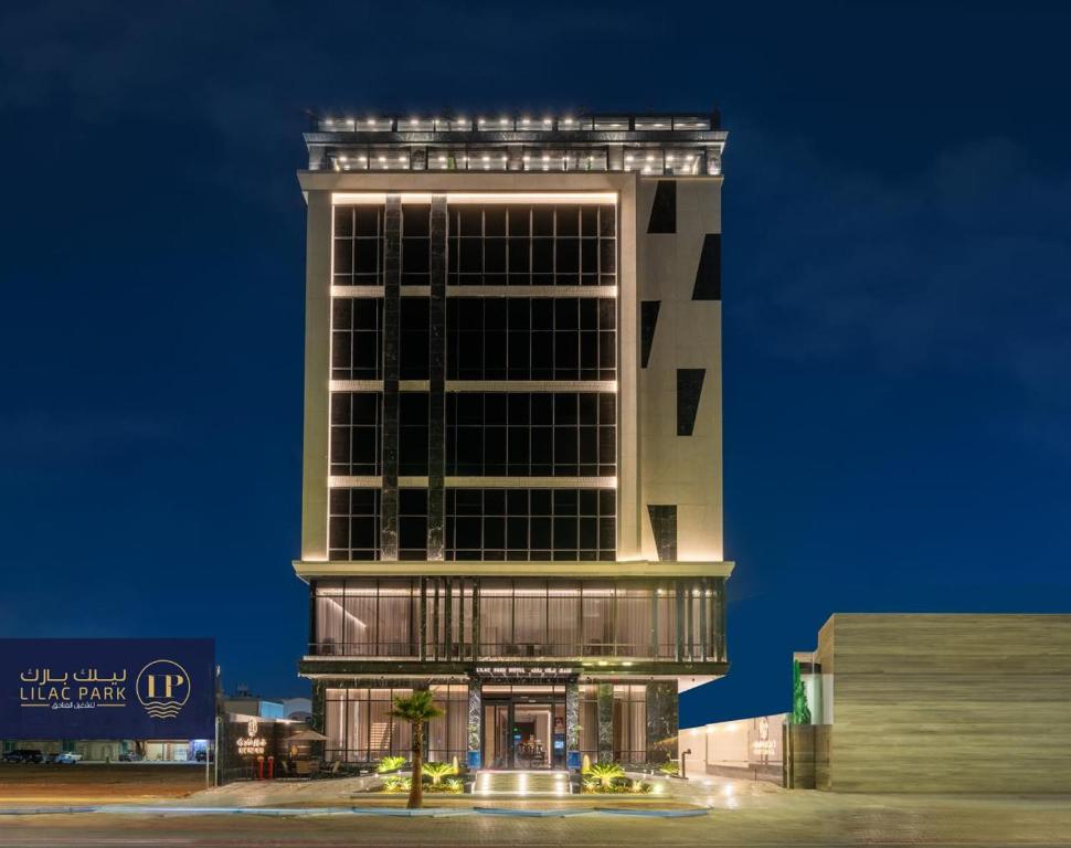 a tall building with lights on top of it at Lilac Park Hotel in Tabuk
