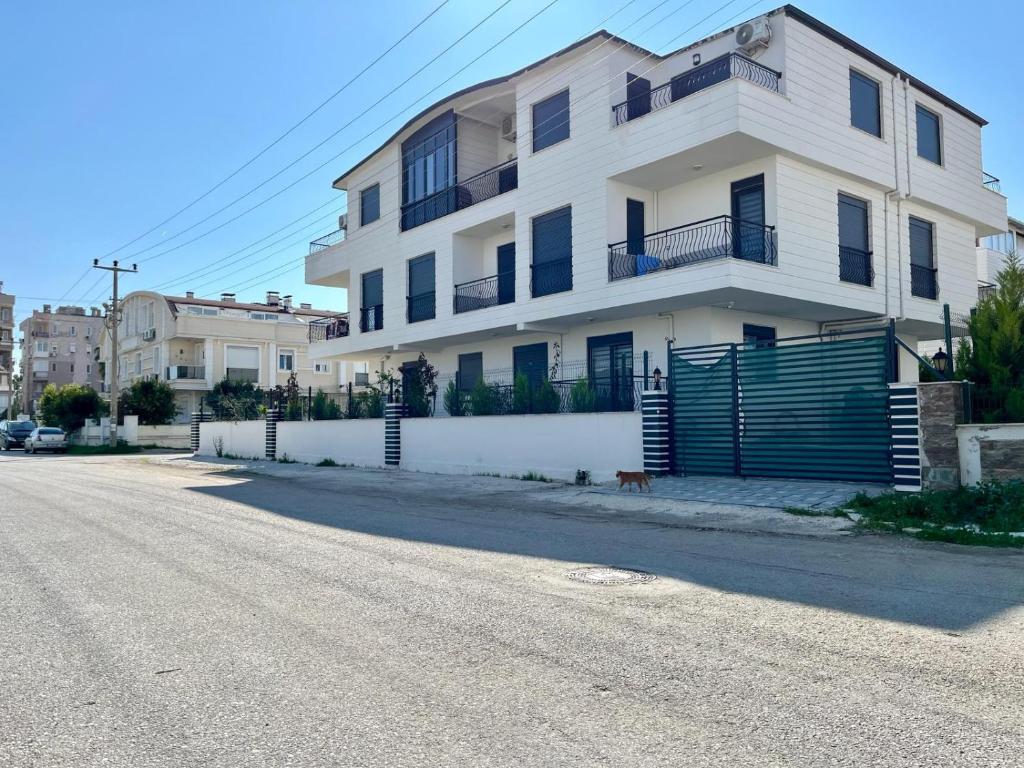 a white building on the side of a street at A flat with two rooms close the Lara Beaches d12 in Altınkum