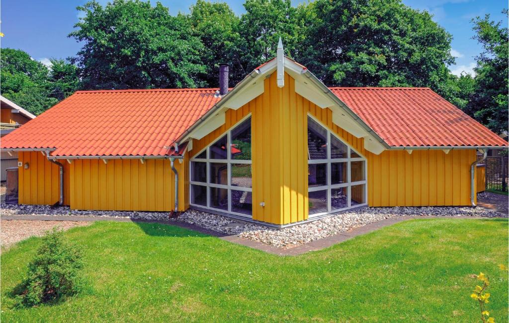 a yellow house with an orange roof at Awesome Home In Hejls With 4 Bedrooms, Sauna And Wifi in Hejls