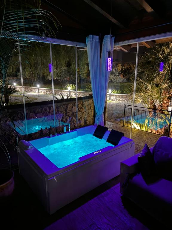 a hot tub in a room with a swimming pool at Green Oasis Gabella in Castelforte