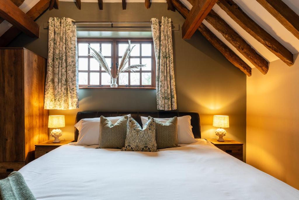 a bedroom with a bed and a window at The Bull on the Green in Newick