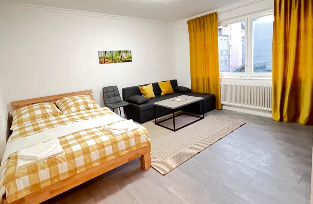 een slaapkamer met een bed, een bank en een tafel bij Wohnung in Schlachthausgasse in Wenen