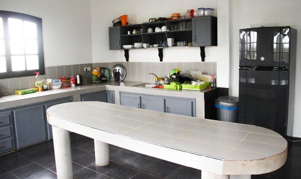 a kitchen with a table in the middle of it at sidi kaouki ayt karoum in Sidi Kaouki
