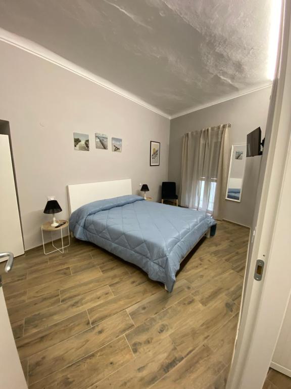 Schlafzimmer mit einem Bett und Holzboden in der Unterkunft La casa nel Vicolo Camera 1 in Casale Monferrato
