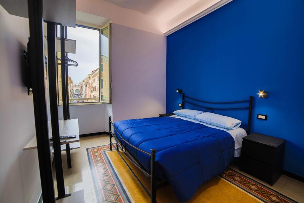 ein blaues Schlafzimmer mit einem Bett mit blauer Wand in der Unterkunft P88 guesthouse in Rom