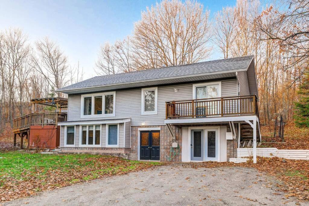 a large house with a porch and a balcony at Meadowcreek Cottage in Utterson