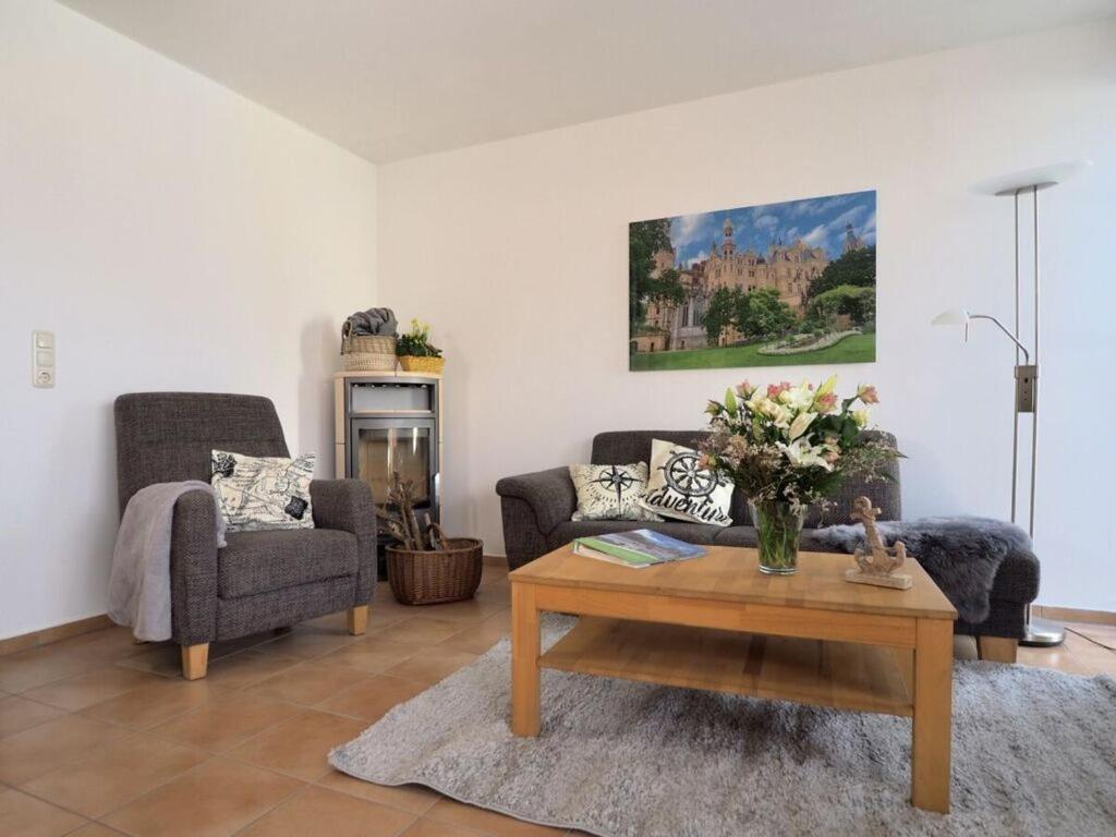 a living room with two chairs and a coffee table at Apartment Captain's Terrace in Unter Göhren
