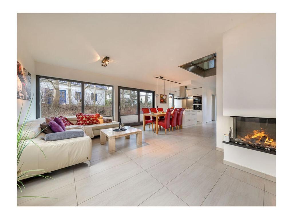 a living room with a couch and a fireplace at Holiday Apartment 1 Comfortable Vacation Home in Juliusruh