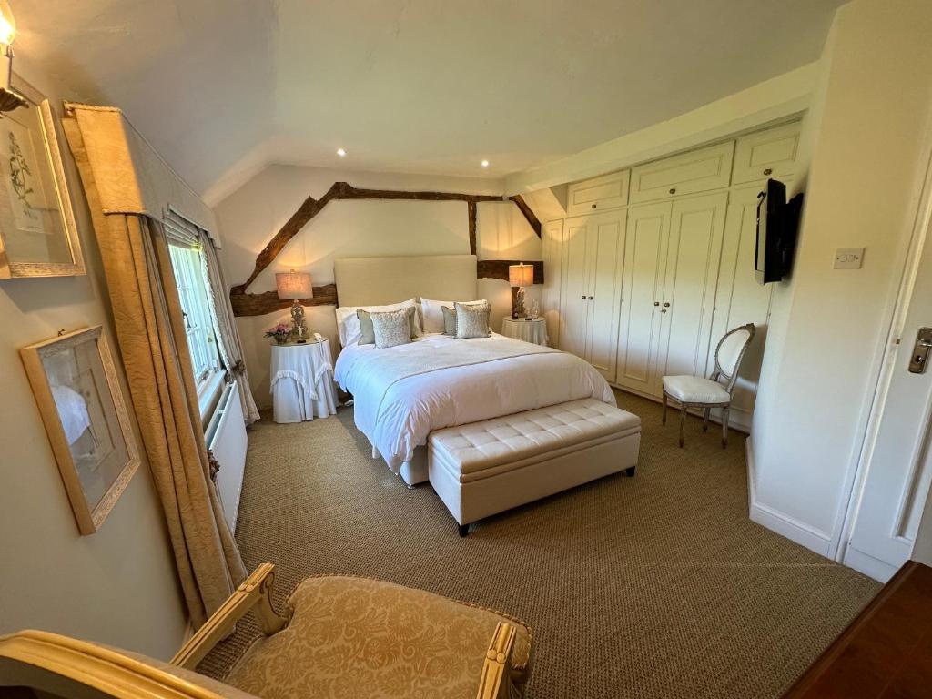 a bedroom with a large bed and a mirror at Well house in Stone