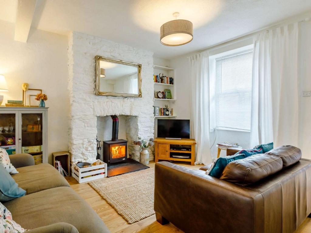 a living room with a couch and a fireplace at 3 Bed in Brixham 64703 in Brixham