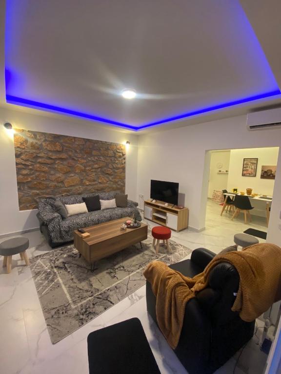 a living room with a couch and a table at Alexandra apartment in Athens