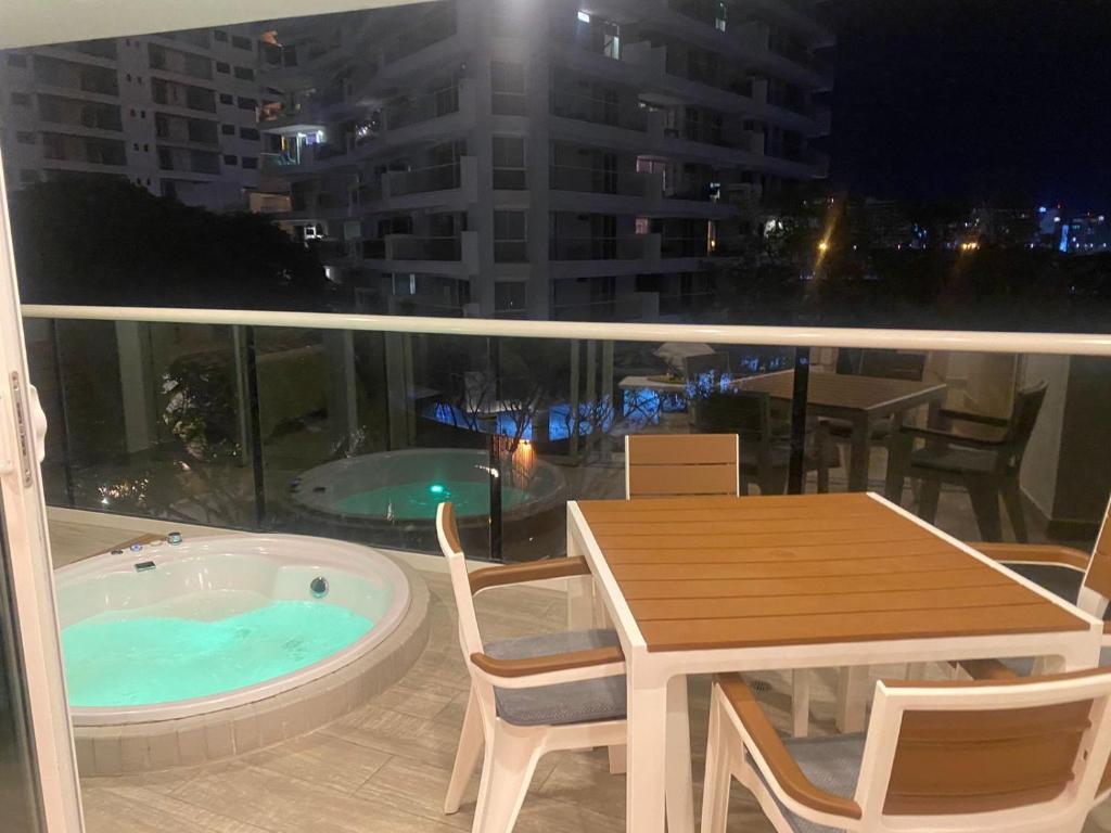 a view of a balcony with a table and a tub at Dominique Cartagena, Beautiful 2 Bedroom Apartment in Cartagena de Indias