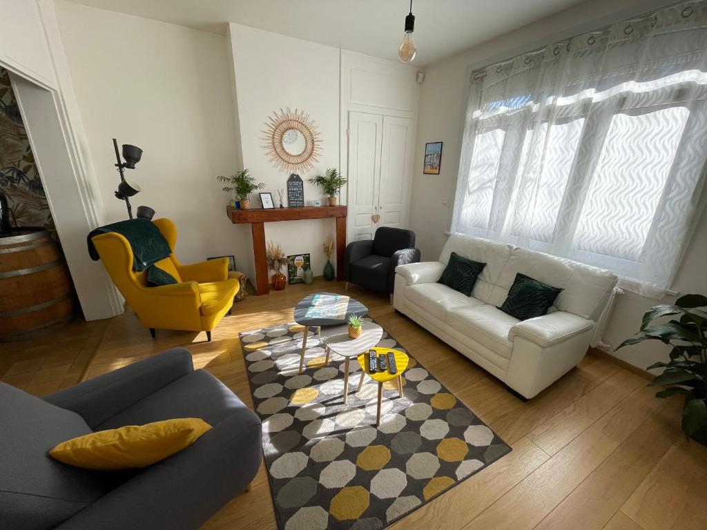 a living room with a couch and a table at La Petite Malouine in Dunkerque