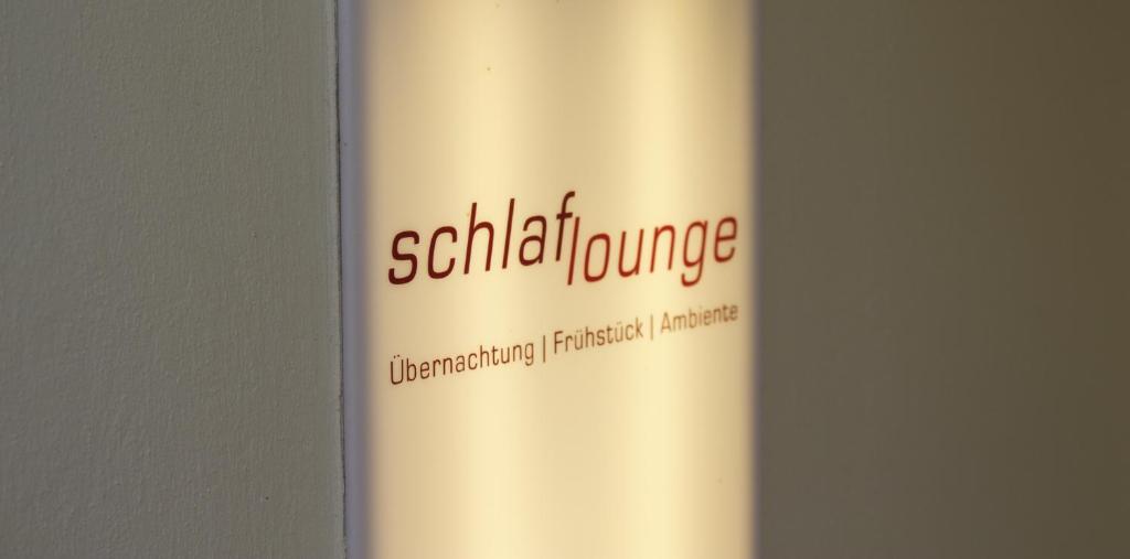 a sign on a wall with a picture of a man on it at Schlaflounge in Hamburg