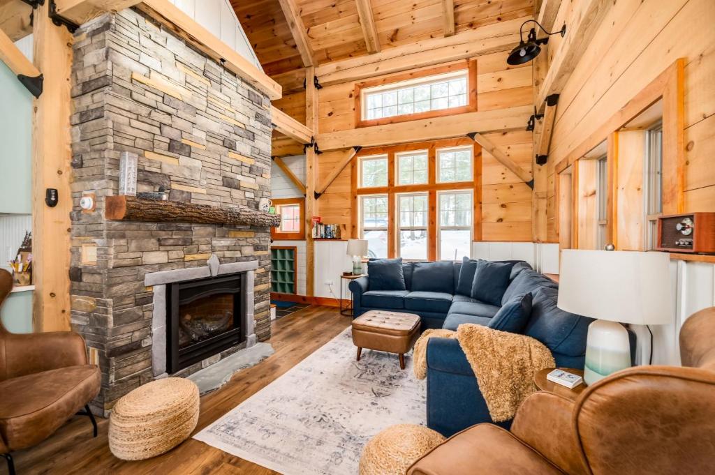 a living room with a couch and a fireplace at Lake Winnipesaukee - Waterfront - 312 in Meredith