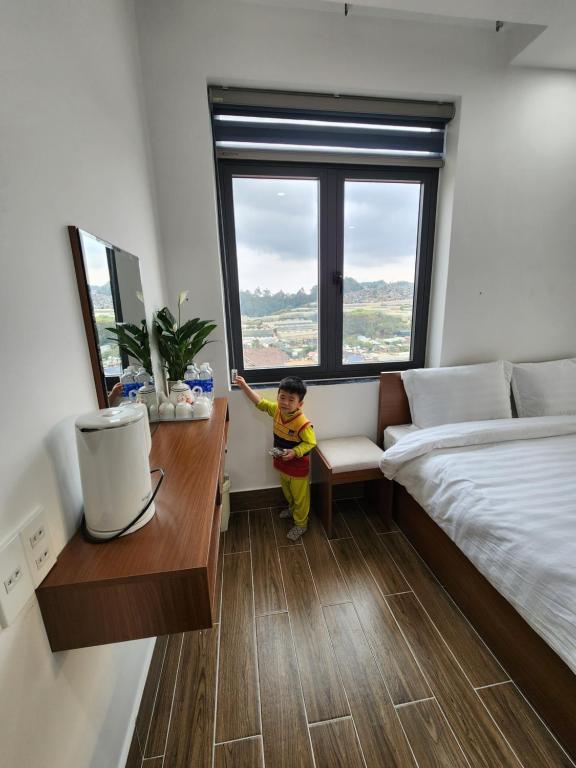 Postel nebo postele na pokoji v ubytování Happy Bun Hotel Da Lat