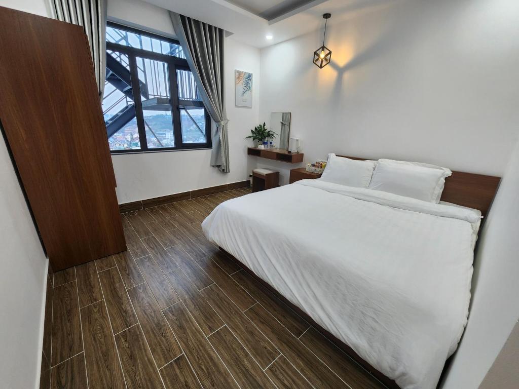 Postel nebo postele na pokoji v ubytování Happy Bun Hotel Da Lat